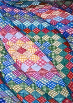 a colorful quilt is laying on the ground