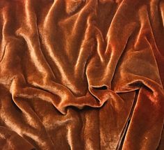 a close up view of a brown velvet material