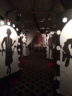 the silhouettes of people are on display in the dark room with lights and drapes