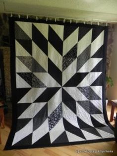 a black and white quilt is on display