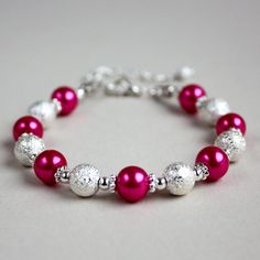 A contemporary beaded bracelet featuring faux glass pearls in hot pink colour and bright silver plated stardust beads. Perfect for any occasion, weddings and parties or as a gift. Organza gift bag included!  Please note that although I take a great care to keep the colours on the photographs as close to reality as possible, they may look slightly different on different monitors. Materials used: Faux glass pearls, pink (8 mm), stardust beads, silver (8 mm), silver colour plated base metal element Bracelet Party, Wedding Bridesmaid Jewelry, Pink Pearls, Wedding Gifts For Bridesmaids, Wedding Jewelry Bracelets, Bridal Bracelet, Wedding Bridesmaid, Organza Gift Bags, Fuchsia Pink