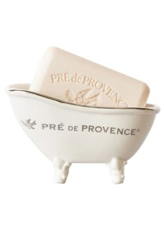 two soap bars sitting on top of each other in a white ceramic bowl with the words pre