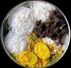 a plate full of food including rice, meat and vegetables with sauce on the side