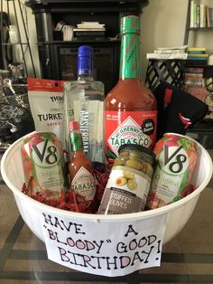 a birthday gift basket with hot sauces, condiments and bottles in it