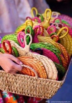 a person holding a basket filled with lots of colorful items