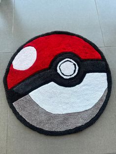 a red and black rug with a pokeball on it