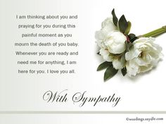 a bouquet of white flowers sitting on top of a table next to a card that says, with sympathy