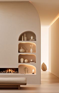 a living room filled with furniture and a fire place next to a wall mounted shelf