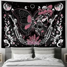 a bed with a black and pink wall hanging over it's headboard,