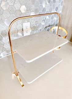 two white trays sitting next to each other on top of a counter in front of a tiled wall