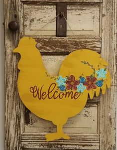 a wooden sign that says welcome with a chicken on it