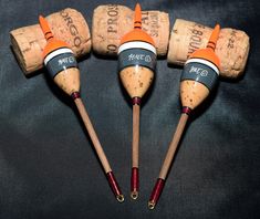 four wine corks are arranged in the shape of three orange and white cones on top of each other