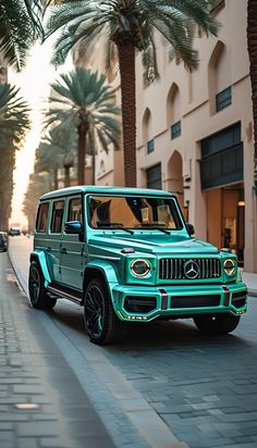 a green jeep parked on the side of a street next to palm trees and buildings