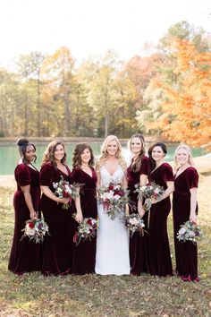 a bride and her bridals in burgundy velvet dresses