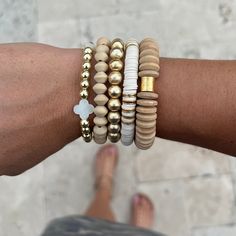 "The Woodlands Stack is a must have! It is a beautiful neutral collection that you will be able to combine with your existing bracelets for endless possibilities!  Makes a beautiful gift for holidays and birthdays! 🤍 The set of 5 contains: 1 - 8mm 14k gold plated ball bracelet (brushed gold) 1 - Telluride wooden disc bracelet 1 - Mother of Pearl quatrefoil and 14k gold plated hematite bracelet 1 - 8mm wooden bicone bead bracelet  1 - 8mm white \"luxe\" heishi bracelet with gold disc accents Bracelets are handmade on strong stretch cord and approximately 7 inches in length, which fits small to medium adult wrists. Custom sizing is available! If you have concerns about sizing, please message me so we can discuss the perfect fit your bracelets." Gold Bead Bracelet Stack, Wood Bead Disc Bracelets, Everyday Beige Jewelry With Wooden Beads, Wooden And Heishi Beads Bracelets As Gift, Everyday Wooden Beads Bracelets, Beige Wooden Beads Bracelet As Gift, Neutral Bracelet Stacks, Gold Heishi Beads Jewelry With Wooden Beads, Gold Stacked Heishi Beads Jewelry