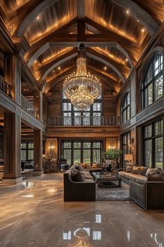 a large living room with high ceilings and chandelier hanging from it's ceiling