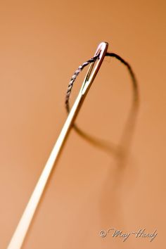 a close up view of the tip of a toothbrush on a brown table top