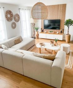 a living room filled with furniture and a flat screen tv on top of a wooden wall