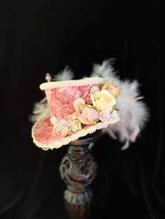 Flowers, feathers and pearls oh my!! This mini top hat has it all and more. This little gem is a one-of-a-kind design and will add a touch of Country French elegance to your mannequin, shop display or worn as a fascinator. This hat is made on a foam base so it is lightweight yet durable. This beauty measures approximately If you are wanting to wear this mini top hat as a fascinator please indicate whether you prefer black or white elastic attached. Also include a measurement of your head from cr Mad Hatter Outfit, Steampunk Stuff, Hat With Flowers, Baby Party Ideas, Lace Hat, Tea Hats, Mini Hats, Mini Top Hat, French Elegance