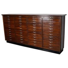 a large wooden cabinet with many drawers