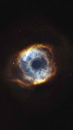 an eyeball in the sky with stars around it