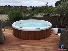 a hot tub sitting on top of a wooden deck