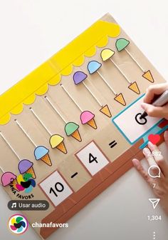 a person is writing numbers on a piece of cardboard