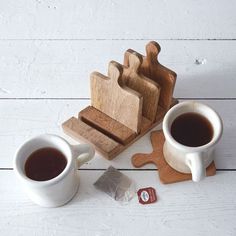 two mugs of coffee sit next to wooden cutting boards