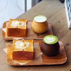 three desserts on wooden plates sitting on top of a table next to each other