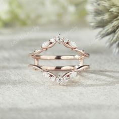 a rose gold wedding ring set with three diamonds