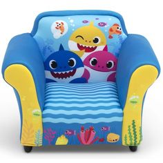 the children's chair has two sharks on it and is blue with yellow arms