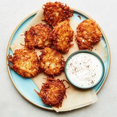 some fried food on a plate with a small bowl of ranch dressing