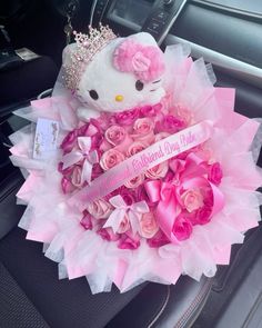 a hello kitty bouquet with pink roses and a tiara