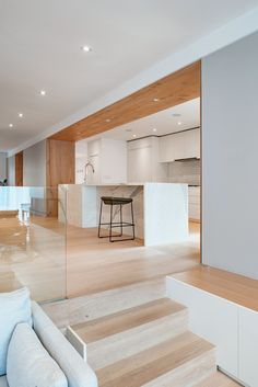 a living room filled with furniture next to a kitchen and dining room table on top of hard wood flooring