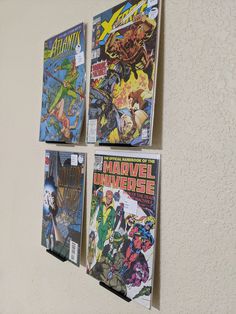 four comics are hanging on the wall next to each other