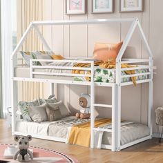 a white bunk bed sitting on top of a wooden floor