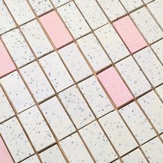 pink and white tiles with dots on them