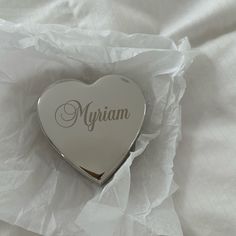 a heart shaped box with the word myjam on it sitting on a white sheet