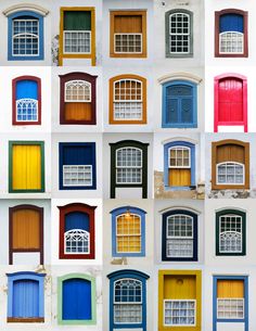 many different colored windows and shutters on a white wall