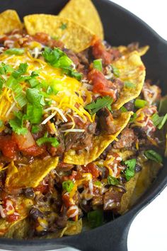 a skillet filled with nachos and cheese