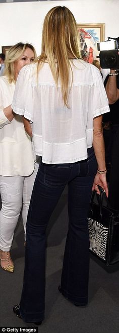 Elle Macpherson flaunts her sculptured figure in a sheer white top Sheer White Top, Pant Jeans, White Sheer Top, White Blouses, Better Body, Convention Center, Art Basel