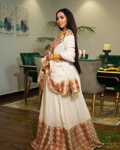 The use of broad, embroidered Tielf paired with the flowing white fabric creates a dynamic contrast, giving the dress a lively yet elegant appearance. This beautiful Habesha kemis is suitable for any kind of cultural celebrations. Material Cotton Menen Thread Estimated delivery : 4 weeks Contact WhatsApp +1(304)-306-2784Email: contact@ethiopian.store Habesha Kemis Modern, Holiday Wedding Dress, Habesha Clothes, Eritrean Dress, Habesha Dress, Ethiopian Traditional Dress, Ethiopian Dress, Habesha Kemis, Dress 2024