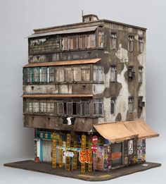 a model of a building with multiple windows and balconies on the top floor