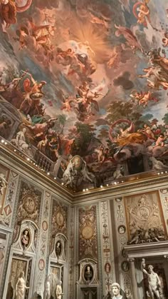 the ceiling is decorated with many paintings and sculptures