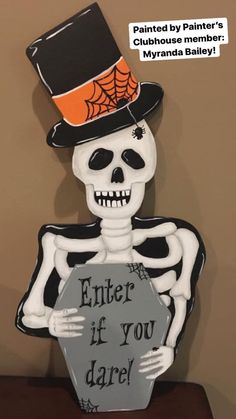 a skeleton wearing a top hat and holding a sign that says enter if you dare