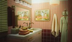 a bathroom with pink tiled walls and white sink, hanging towels on the wall next to it