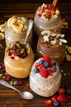 three jars filled with food sitting on top of a wooden table