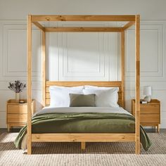 a bedroom with a four poster bed and nightstands