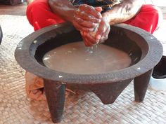 a woman is pouring water into a bowl