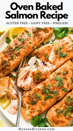 salmon on a plate with lemon wedges and parsley garnished with herbs